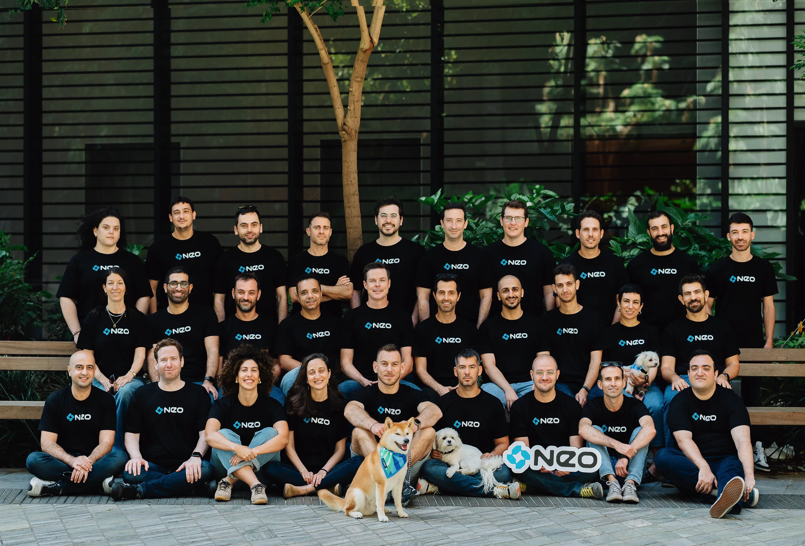 The Neo team gathered together outdoors